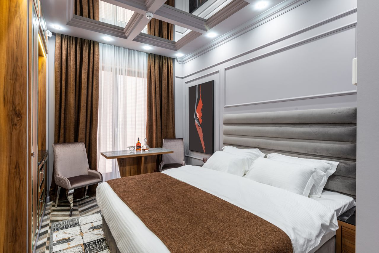 Grey velvet suite with seating nook, whiskey service and coffered ceiling